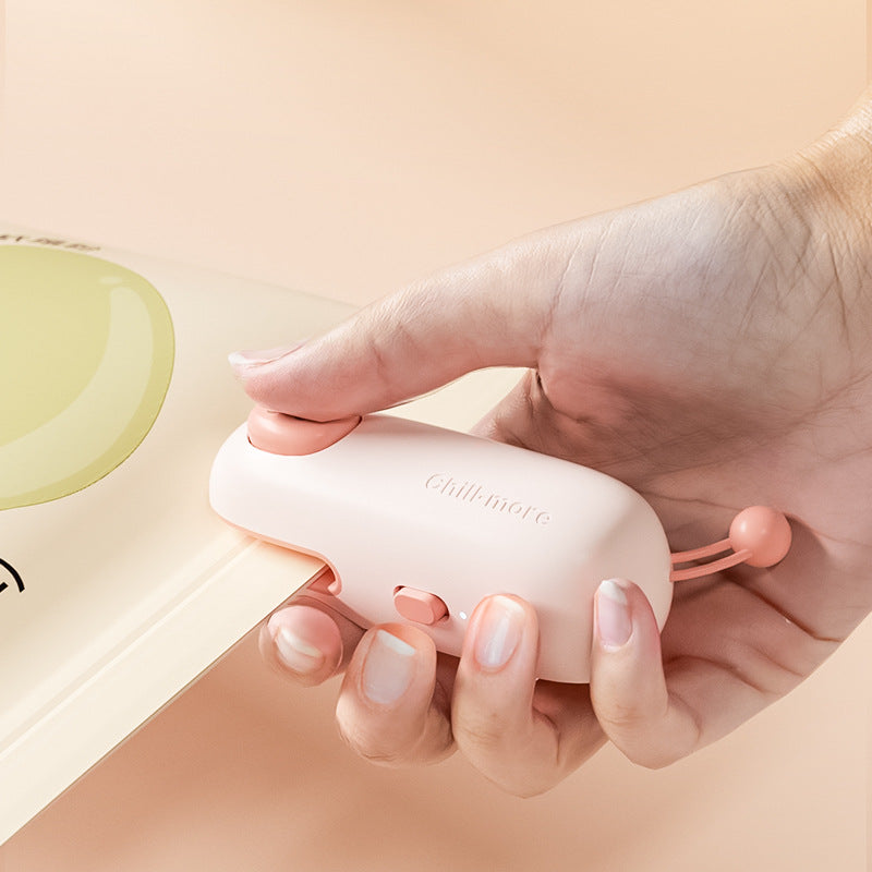 Pink Pig rechargeable bag sealer used to seal a plastic food-storage bag